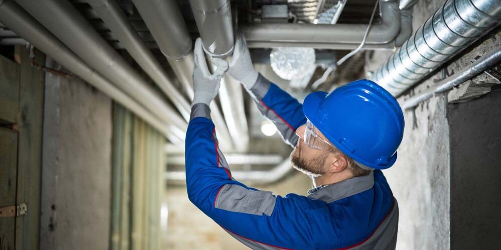 Plumber inspecting a leaky pipe Columbia, SC